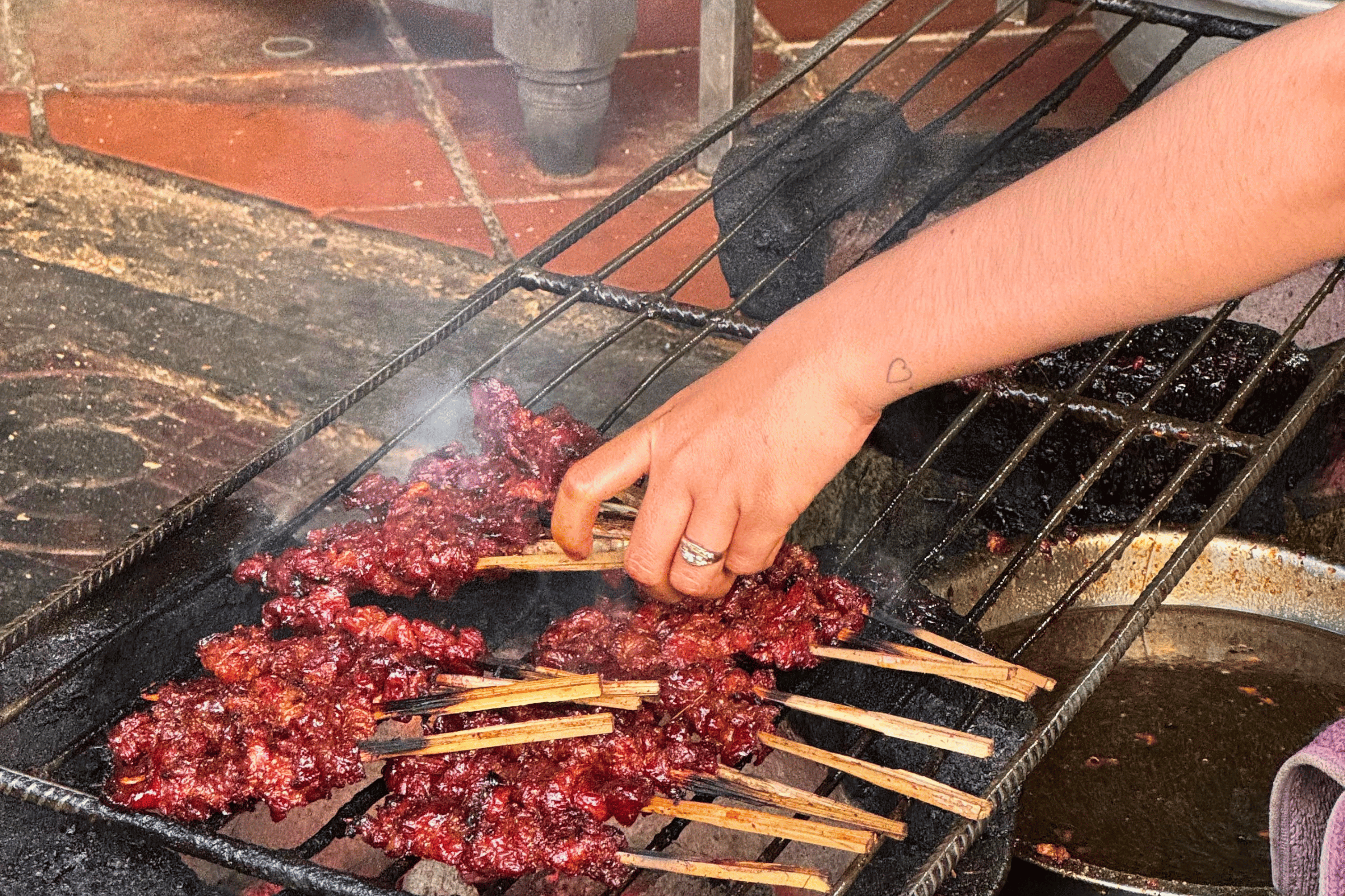 Marinated skewers grilling.