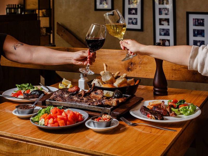 Cheers over parrilla.