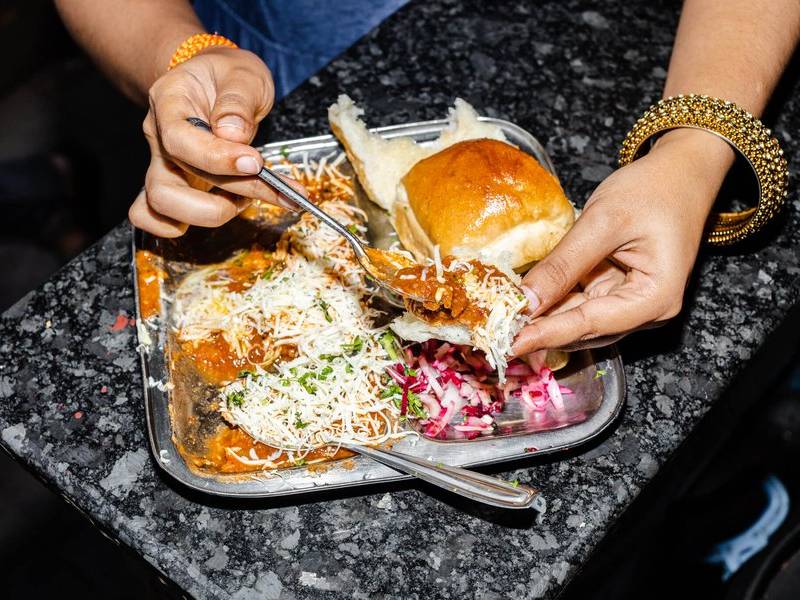 Tearing into pav bhaji.