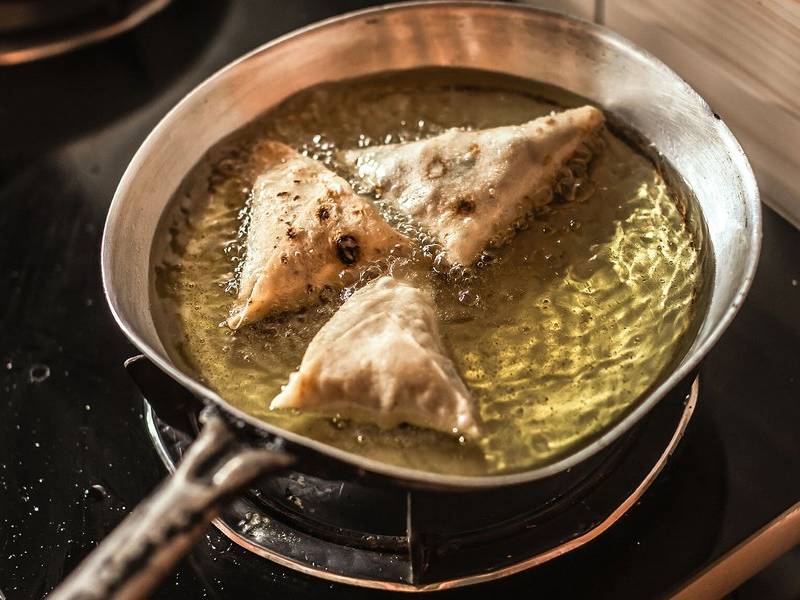 Frying samosas.