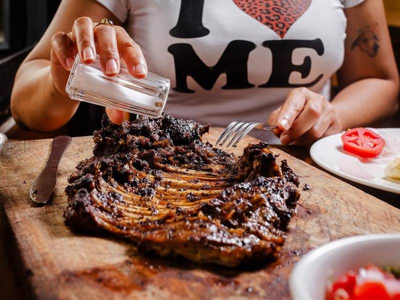 Salting steak.