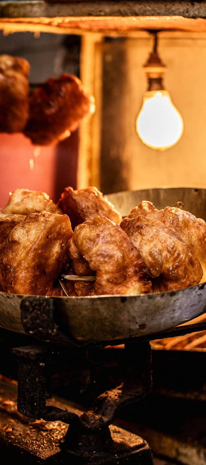 Crisp Sfenj out of the fryer.