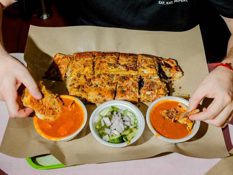 Dipping the murtabak.