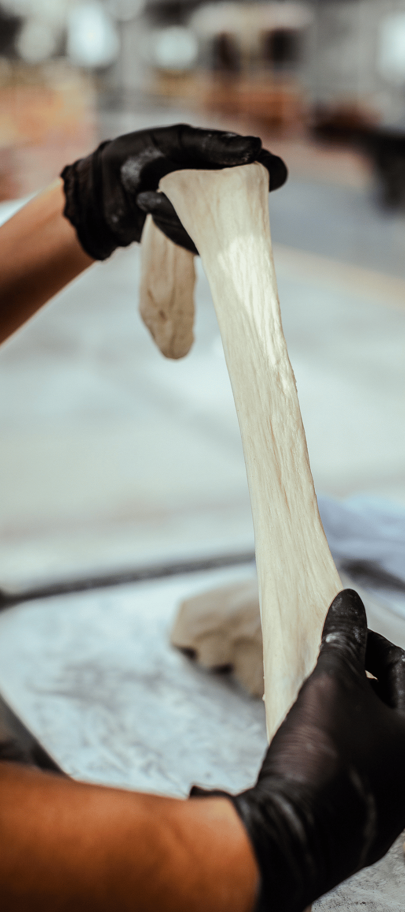 Stretching cassava dough.