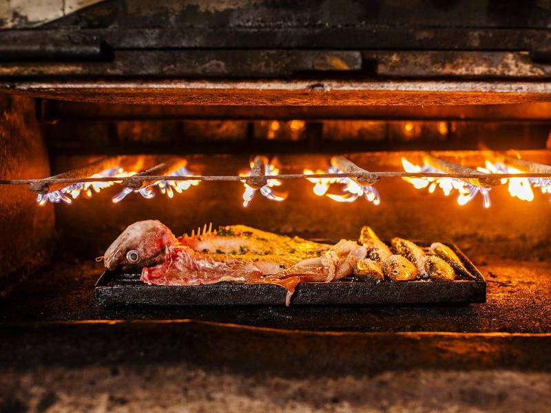Under the flame.