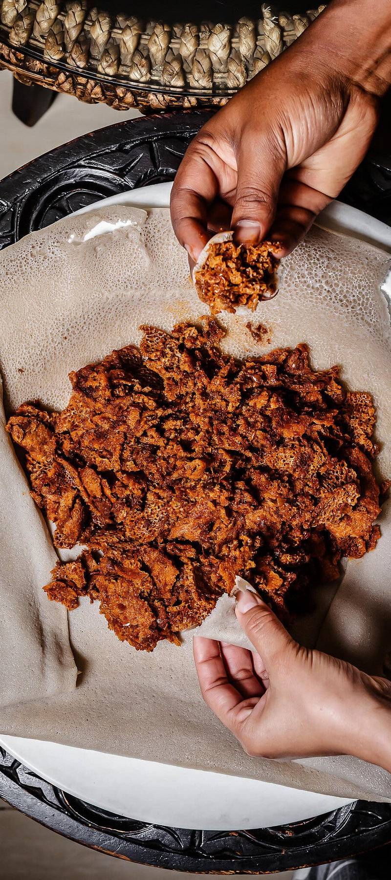 Tearing injera.
