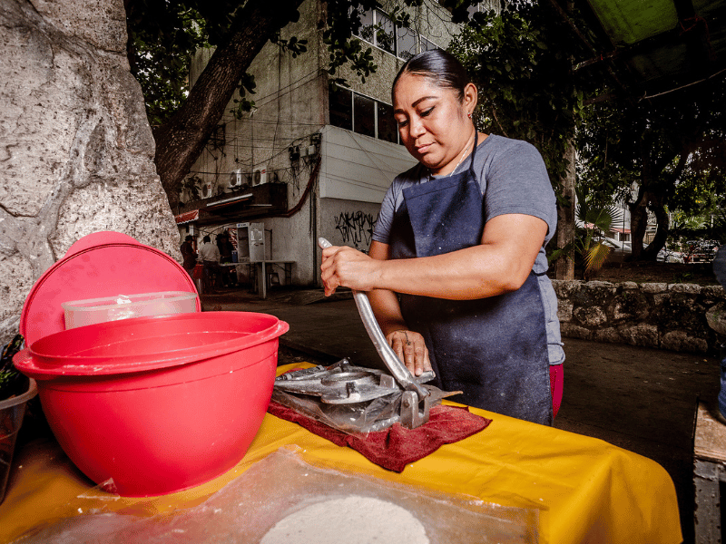 Pressing tortillas.
