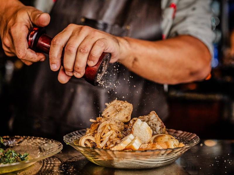 Grinding the pepper.