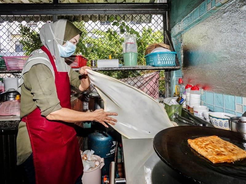 Slapping roti dough.