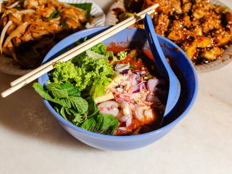 Assam laksa with fresh herbs.