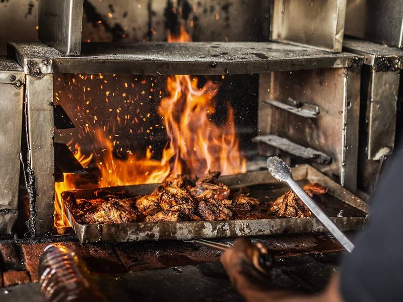 Stoking the charcoal fire.