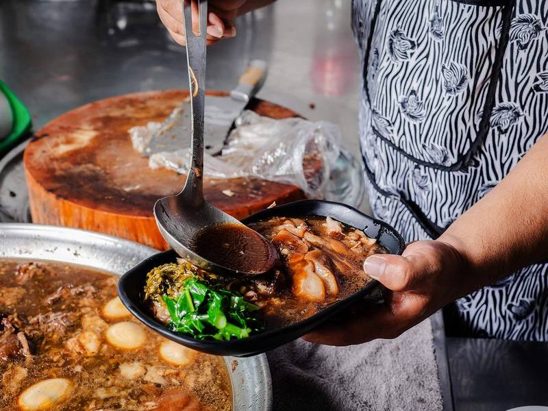 Ladling the broth.