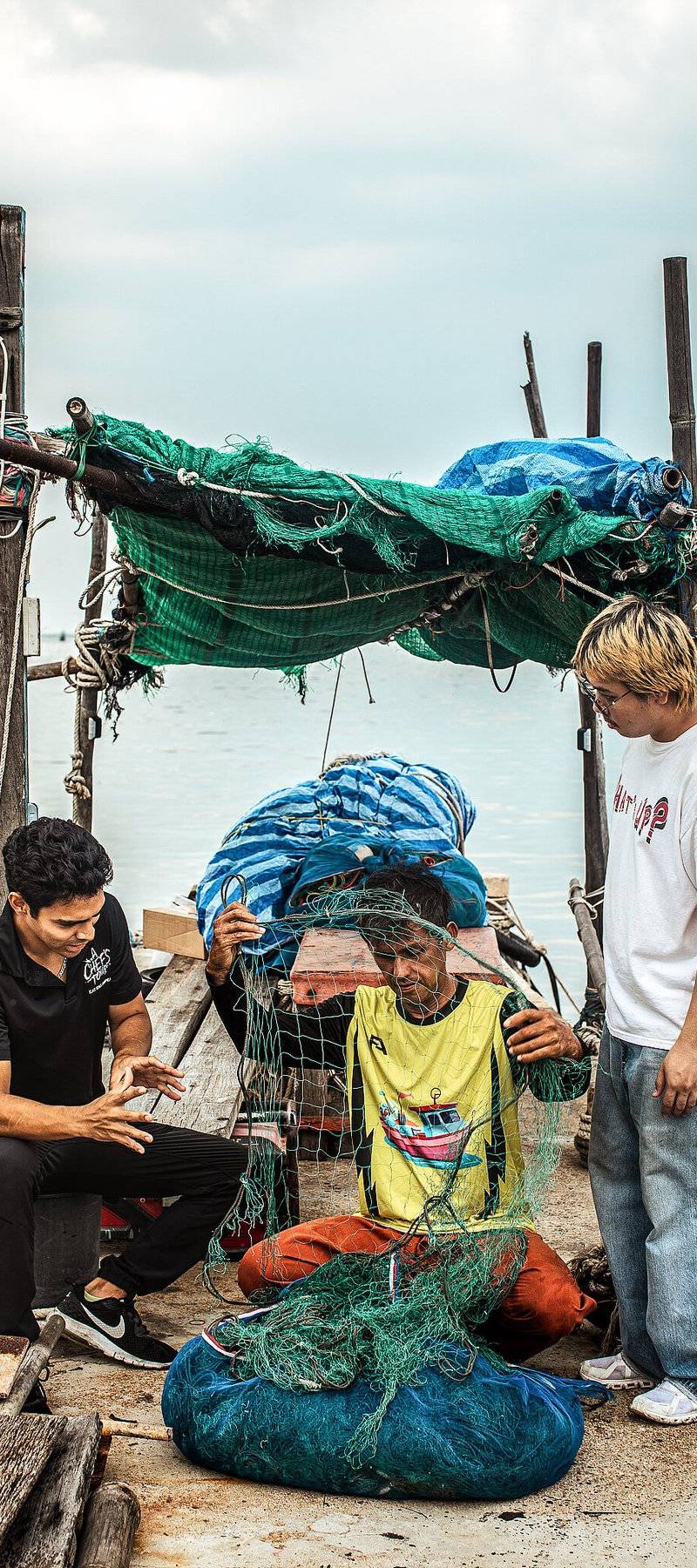 Fishermen, mending the net.