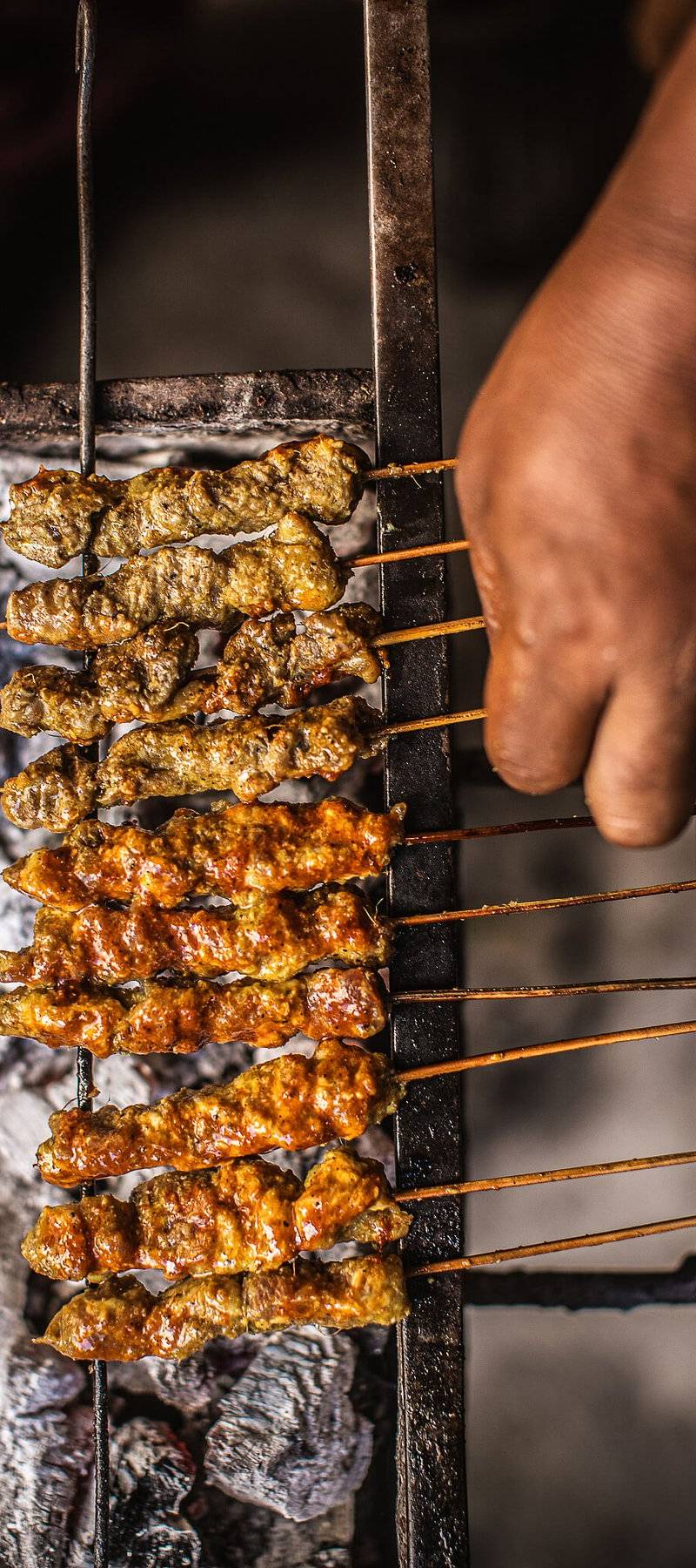 Mishkaki grilling over charcoal.