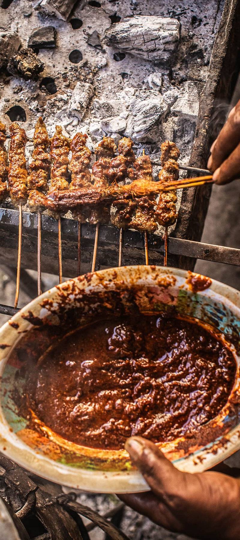 Saucing mishkaki.