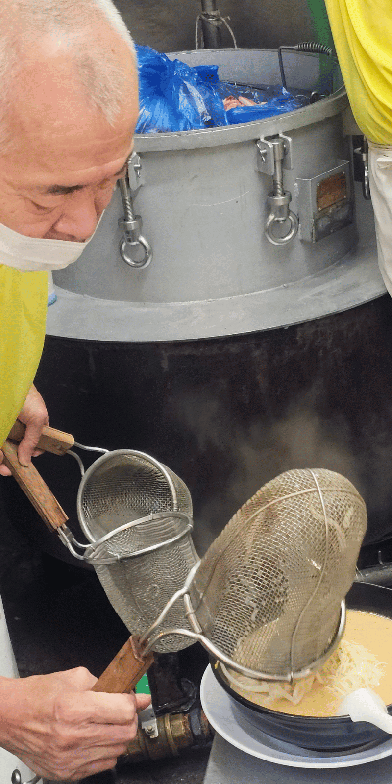 Straining ramen noodles.