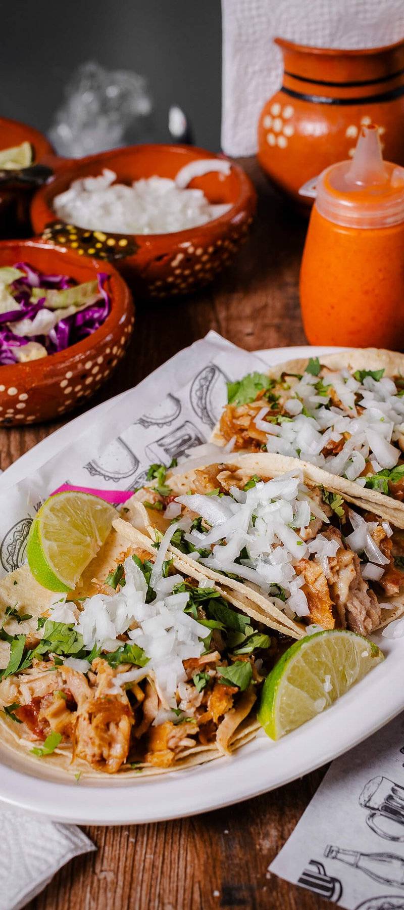 Al pastor tacos with onions.