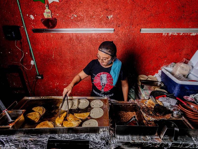 Frying the birria tacos.