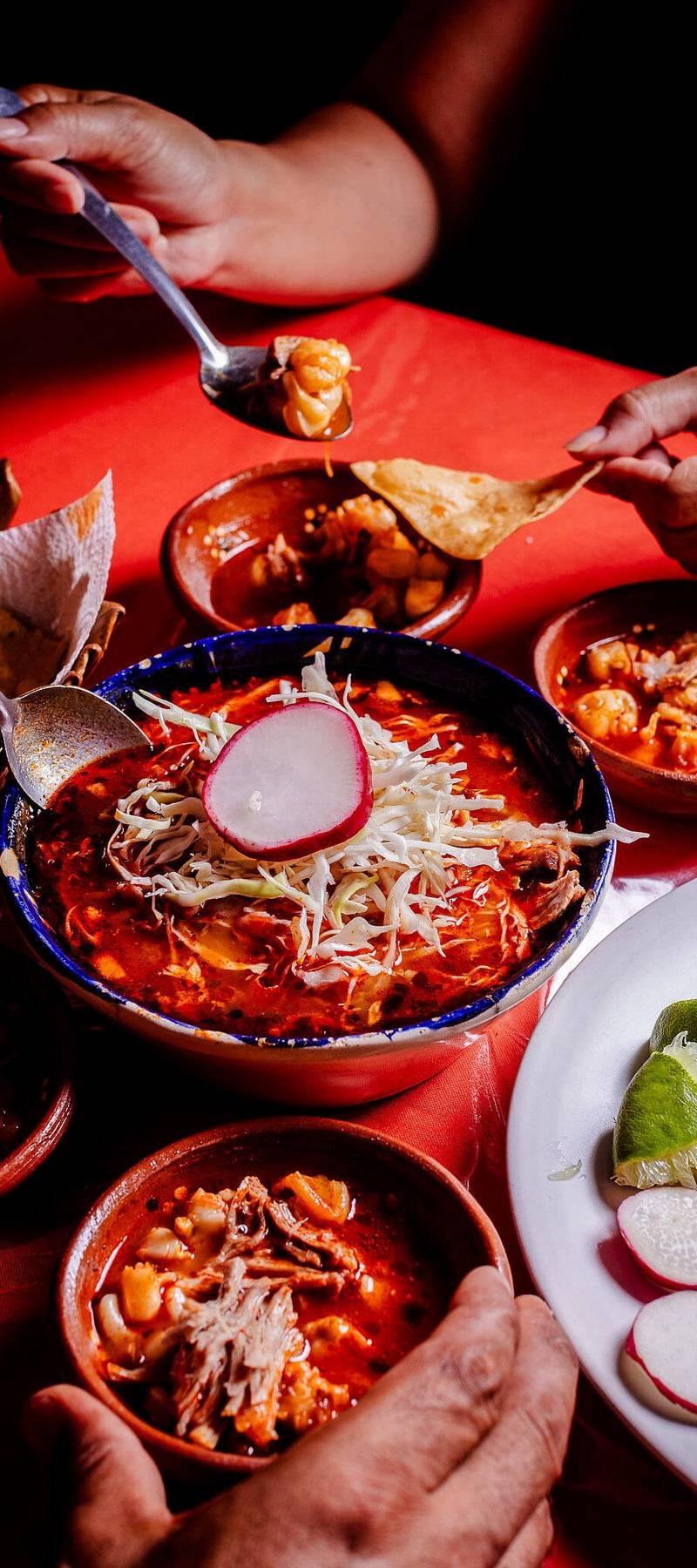 Pozole rojo with accompaniments.