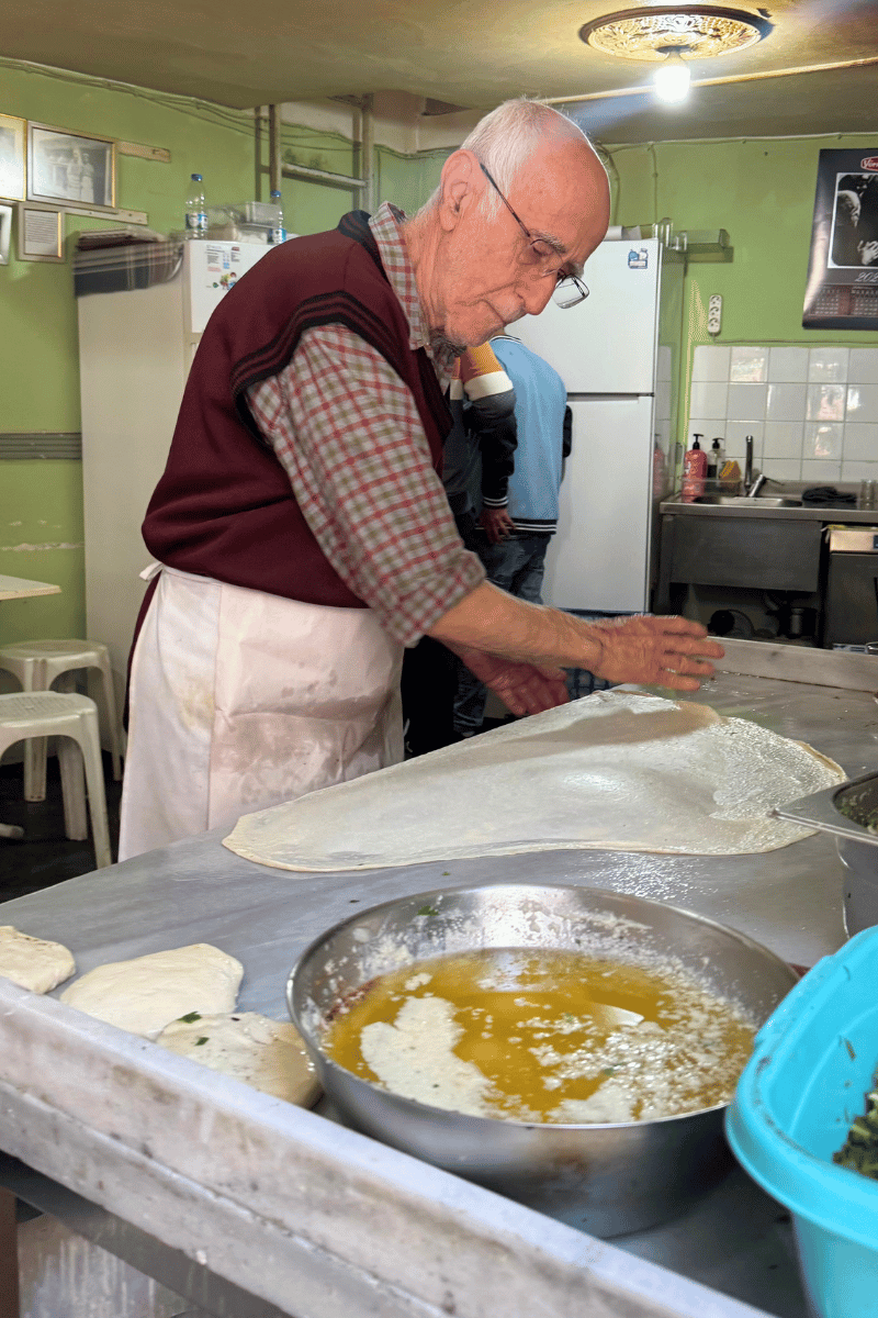 Slapping börek dough.