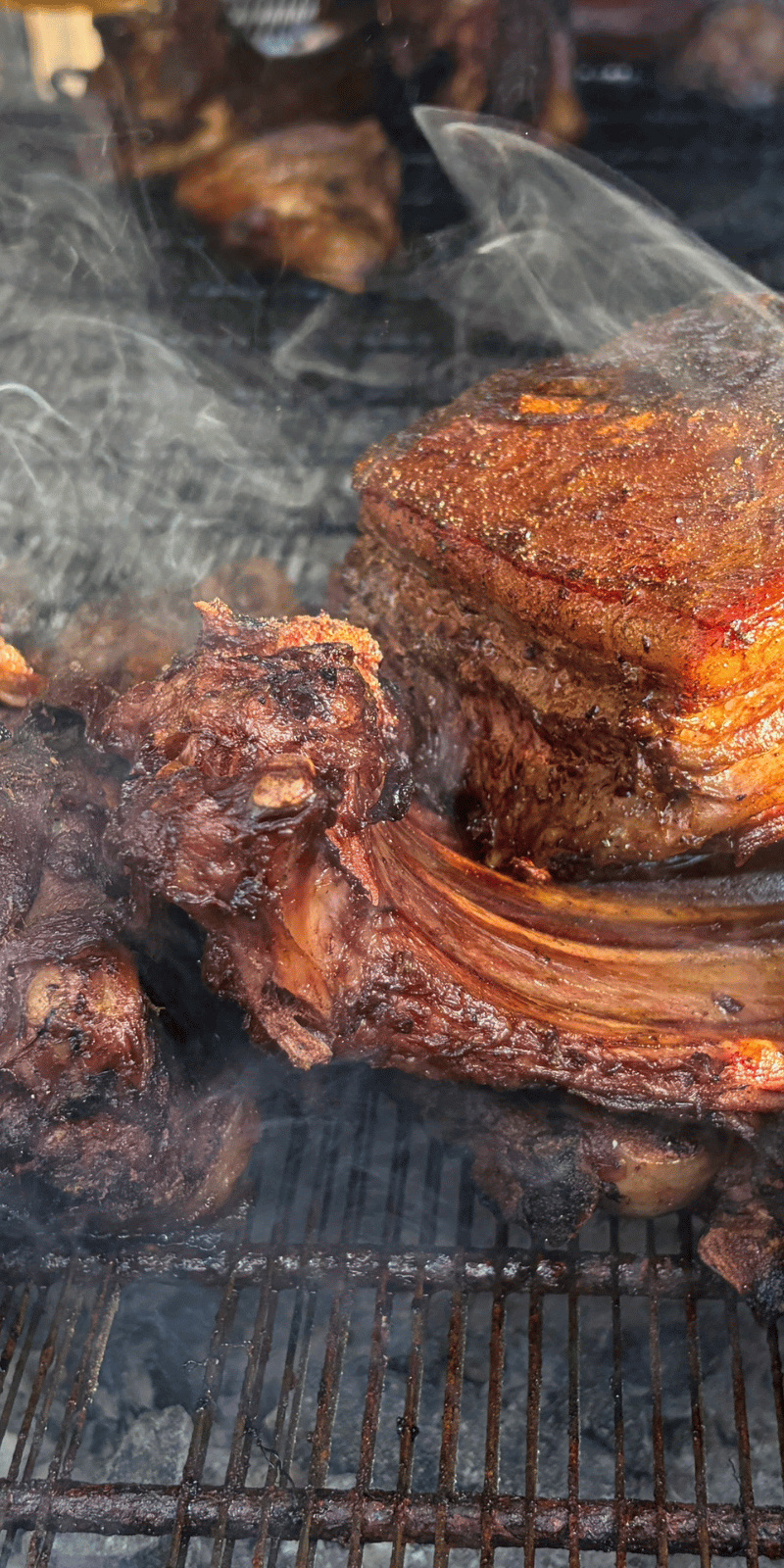 Smoky meat on the barbecue.